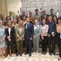 President Isaac Herzog and his wife Michal (to his right) pose with members of the President's Climate Forum, at the President's Residence in Jerusalem on May 17, 2022. Dov Khenin is third from right, while Zohar Berman is second from the left. (Amos Ben-Gershom/GPO)