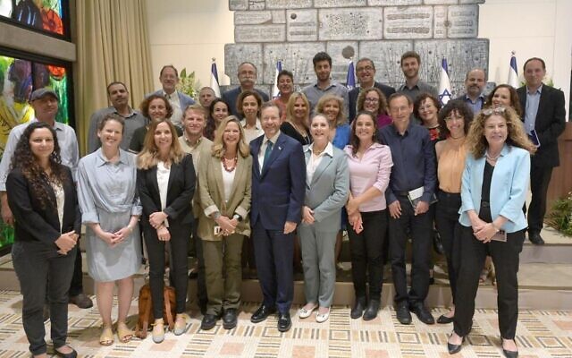 President Isaac Herzog and his wife Michal (to his right) pose with members of the President's Climate Forum, at the President's Residence in Jerusalem on May 17, 2022. Dov Khenin is third from right, while Zohar Berman is second from the left. (Amos Ben-Gershom/GPO)