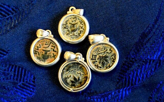 Antique coins were incorporated into the pendants in order to sell them as jewelry seized in a massive illegal trade bust on May 15, 2022 in Modi'in. (Yoli Schwartz/Israel Antiquities Authority)