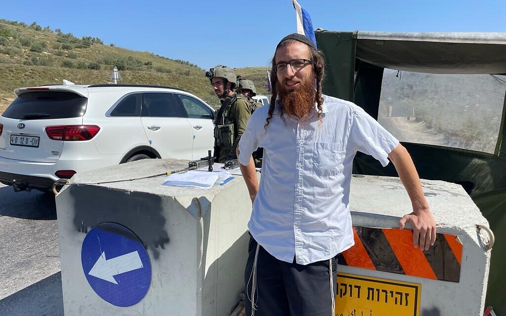 Yeshiva administrator Shmuel Wende at a checkpoint blocking the road to Homesh, May 26, 2022. (Carrie Keller-Lynn/The Times of Israel)