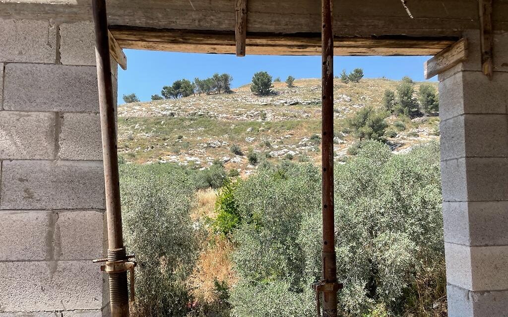 The view from an unfinished home in the Palestinian village Burqa onto the Homesh hilltop, May 26, 2022. (Carrie Keller-Lynn/The Times of Israel)