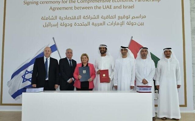 Israeli Minister of Economy and Industry Orna Barbivai signs a free trade agreement with the United Arab Emirates in Dubai, Israel's first with an Arab country, May 31, 2022. From left to right: Ohad Cohen, director of the Foreign Trade Administration at the Israel Ministry of Economy and Industry, Israeli Ambassador to the UAE Amir Hayek, Israeli Minister of Economy and Industry Orna Barbibai, Emirati Minister of Economy Abdulla bin Touq Al-Marri, Emirati Minister of State for Foreign Trade Thani bin Ahmed Al Zeyoudi, Emirati Ambassador to Israel Mohamed Al Khaja, and Juma Al Kait, director of the Emirati Foreign Trade Administration (Anuj Taylor, Strap Studios)