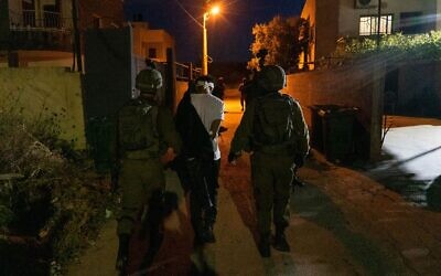 Israeli soldiers arrest a suspect in the West Bank town of Rummanah, May 9, 2022. (Israel Defense Forces)