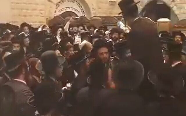 Haredi worshipers who broke into the Mount Meron compound celebrate in a courtyard on May 19, 2022 (video screenshot)