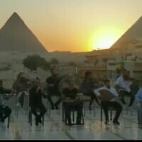 Israel's Firqat Alnoor orchestra plays in front of the pyramids in Cairo as part of the Israeli Embassy's Independence Day celebrations in May 2022. (Screencapture/Kan)