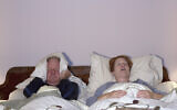 Illustrative image: A woman snores as her husband covers his ears (karenfoleyphotography via iStock by Getty Images)