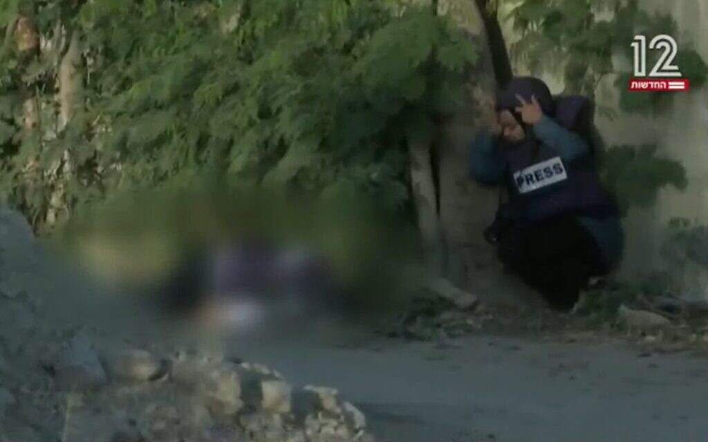The site in Jenin where journalist Shireen Abu Akleh (blurred) was seen fatally shot early on May 11, 2022, as a colleague looks on (Channel 12 screenshot; used in accordance with clause 27a of the copyright law)