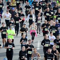 Runners take part in a marathon in Israel's coastal city of Tel Aviv on February 25, 2022. (Avshalom Sassoni/Flash90)
