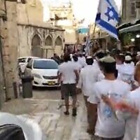 Israeli youths march through the Muslim Quarter in Jerusalem's Old City on May 28, 2022, on the eve of the Jerusalem Day flag parade. (Screenshot/Twitter)