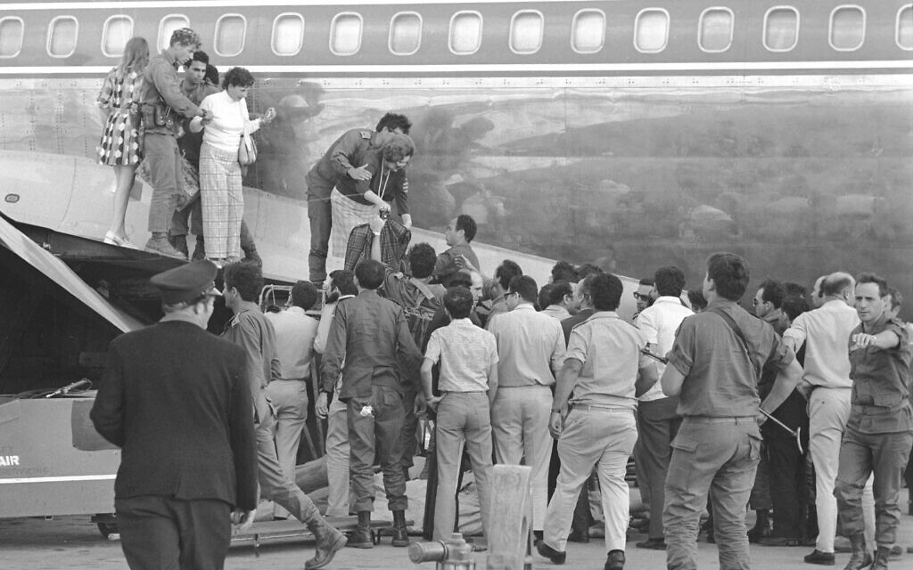 Security forces help passengers and crew off Sabena flight 571, following its 1972 hijacking at Lod Airport (Ron Ilan/Israel Defense Forces Archive)