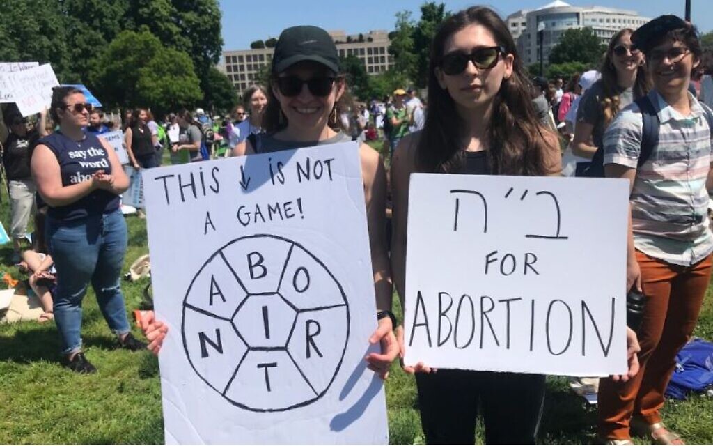 Members of the crowd holding signs that read 'This is not a game,'and 'B”H (Thank God) for Abortion' at a pro-abortion rights rally organized by the National Council of Jewish Women in Washington, DC, May 17, 2022. (Julia Gergely)
