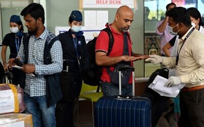 Health workers screen passengers arriving from abroad for monkeypox symptoms at Anna International Airport terminal in Chennai on June 03, 2022. (Arun Sankar/AFP)