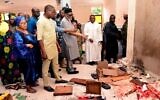 Ondo State Governor Rotimi Akeredolu (third left) points to the blood stained floor after an attack by gunmen at St. Francis Catholic Church in Owo town, southwest Nigeria, June 5, 2022. (AFP)