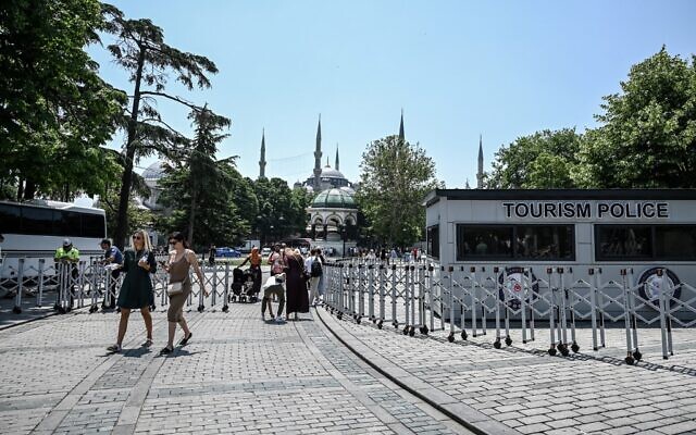 Tourists pass through a police checkpoint in Istanbul as Blue Mosque (sultanahmet) and Hagia Sophia Mosque are surrounded by a police fence for security reasons, on June 14, 2022 (Ozan KOSE / AFP)