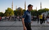 A Turkish police officer walks in front of the Blue Mosque in Istanbul, on June 14, 2022. (Yasin Akgul/AFP)