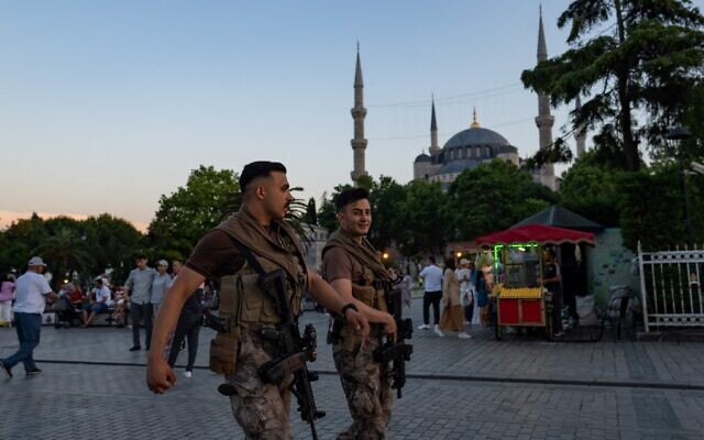Turkish riot police officers walk in front of the Blue Mosque in Istanbul on June 14, 2022. (Yasin AkgulAFP)