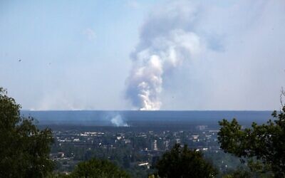 A picture taken on June 21, 2022, from the town of Lysychansk shows a large plume of smoke rising on the horizon behind the town of Severodonetsk, amid the Russian invasion of Ukraine. (Anatolii Stepanov/AFP)