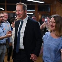 Liberal Democrat Party candidate Richard Foord (center) arrives with his wife Kate at the count for district by-election results at the count center in Crediton, south-west England on June 24, 2022. (Justin Tallis/AFP)