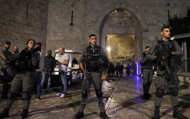 Police officers stand guard as they close off access to the Damascus Gate entrance of Jerusalem's Old City, on June 28, 2022. (Ahmad Gharabli/AFP)