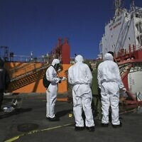 Experts investigate a toxic gas explosion in Jordan's Red Sea port of Aqaba, Tuesday, June 28, 2022. (AP Photo/Raad Adayleh)