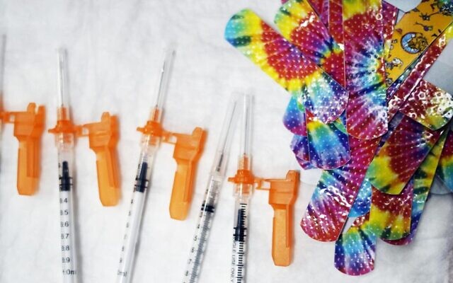 Illustrative: Syringes and colorful bandages are prepared as children from local schools prepare to get COVID-19 vaccines in Pittsfield, Mass., on December 13, 2021. (Ben Garver/The Berkshire Eagle via AP, File)