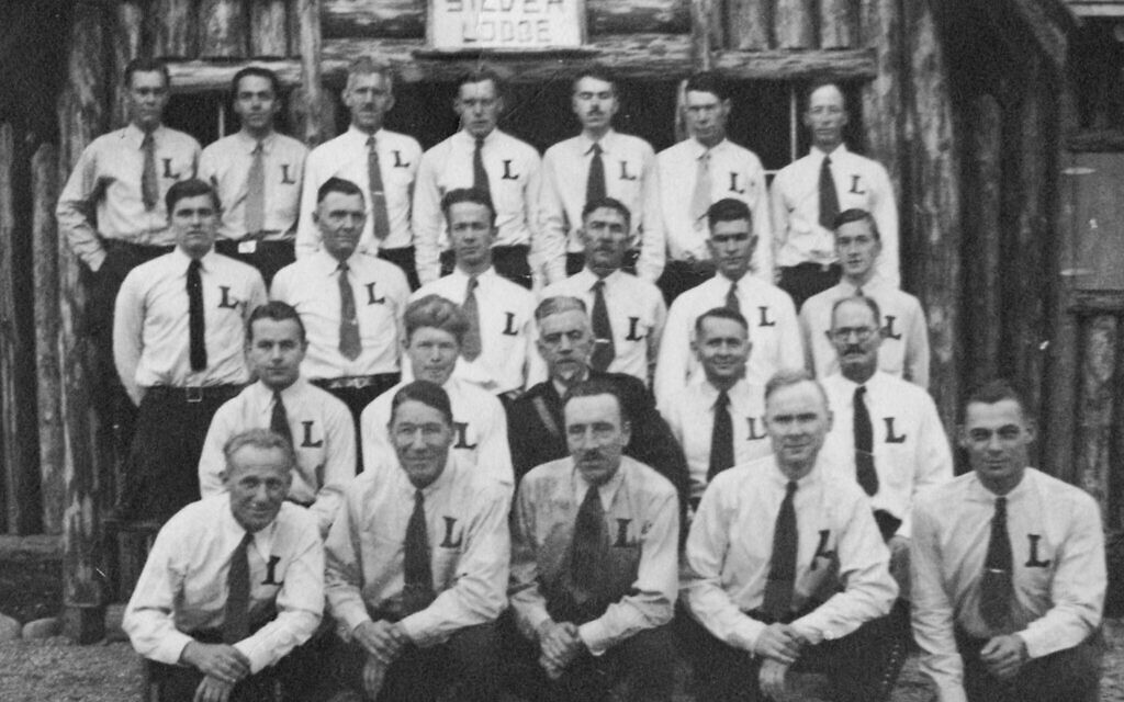 William Pelley (in the dark uniform) and Silver Legion members gather in front of the Silver Lodge in Redmond, Washington, in 1936. Note the toothbrush Hitler mustaches in the front and back rows. (University Libraries, University of Washington, Special Collections, Collection: PH 1521.9, Negative no. UW 39131/courtesy Michael Benson)