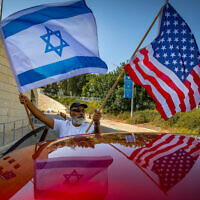 ILLUSTRATIVE IMAGE: Israeli supporters of Donald Trump wave United States and Israeli flags to support his candidacy outside the US embassy in Jerusalem on October 27, 2020. (Olivier Fitoussi/Flash90)
