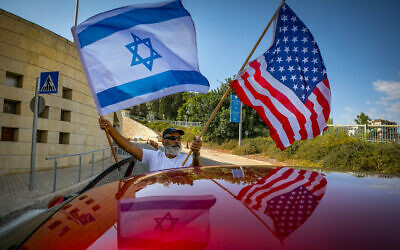 ILLUSTRATIVE IMAGE: Israeli supporters of Donald Trump wave United States and Israeli flags to support his candidacy outside the US embassy in Jerusalem on October 27, 2020. (Olivier Fitoussi/Flash90)