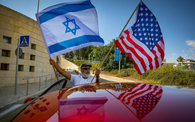 Israeli supporters of Donald Trump wave United States and Israeli flags to support his candidacy outside the US embassy in Jerusalem, on October 27, 2020. (Olivier Fitoussi/Flash90/File)