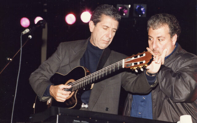 Leonard Cohen tuning his guitar onstage in an undated photo. (Courtesy of Leonard Cohen Family Trust)
