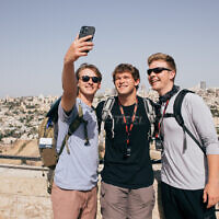 Christian tourists in Israel through the 'Passages' program pose for a selfie on Jerusalem's Haas Promenade overlooking the capital's Old City, in an undated photograph. (Mattanah DeWitt/Passages)