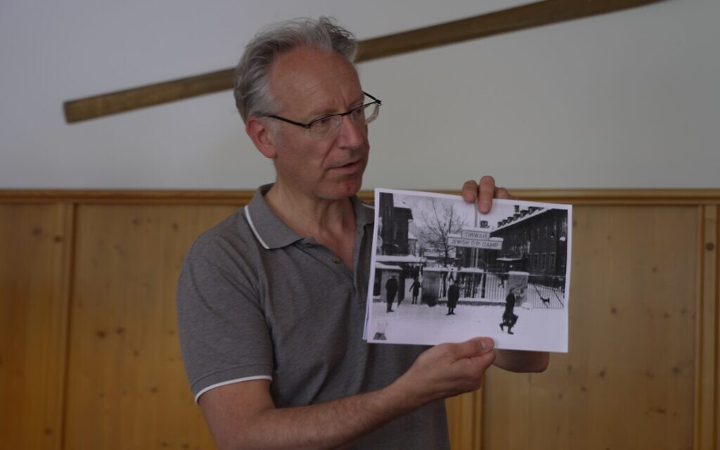 Dr. Johannes Lang shows a photo of the Bad Reichenhall army base in the days that it housed Jewish DPs and was called Camp Tikvah, May 2022. (Alexander Vexler)