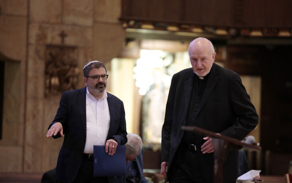 Rabbi Asher Lopatin, left, of the JCRC/AJC talks to Msgr. Patrick Halfpenny at the Shrine of the Little Flower in Royal Oak, Michigan, on May 31, 2022. (Photo by Jeff Kowalsky for JTA)