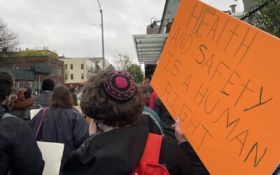 Rabbi Rachel Goldenberg holds a sign reading 'Health and safety is a human right' at the launch of the Cabricanecos Campaign in early March. (JFREJ)
