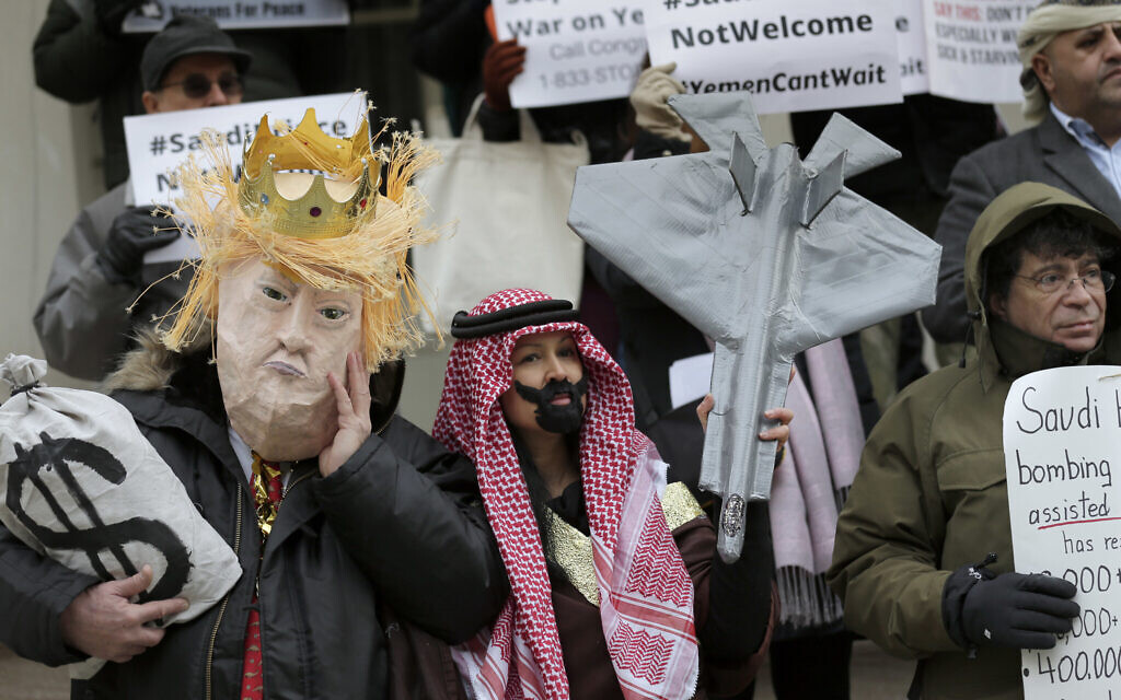Protesters, some dressed as United States President Donald Trump and Crown Prince Mohammed bin Salman, stand on the steps of City Hall in New York, Tuesday, March 20, 2018. (AP/Seth Wenig)