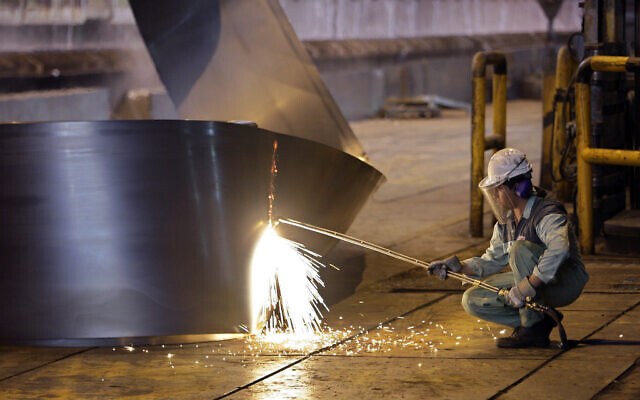 Illustrative - In this May 31, 2012 file photo, an Iranian worker cuts a steel roll (AP Photo/Vahid Salemi, File)