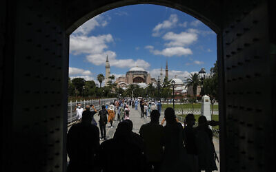 People walk towards the Byzantine-era Hagia Sophia, one of Istanbul's main tourist attractions in the historic Sultanahmet district of Istanbul, Saturday, July 11, 2020. (AP/Emrah Gurel)