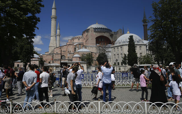 People take pictures outside the Byzantine-era Hagia Sophia, one of Istanbul's main tourist attractions in the historic Sultanahmet district of Istanbul, July 11, 2020. (Emrah Gurel/AP)