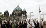 FILE - People carry crosses during a silent protest against abortion in front of the Berlin Cathedral in Berlin, Sept. 26, 2009 (AP Photo/Franka Bruns, File)
