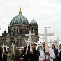 People carry crosses during a silent protest against abortion in front of the Berlin Cathedral in Berlin, September 26, 2009. (AP Photo/Franka Bruns, File)