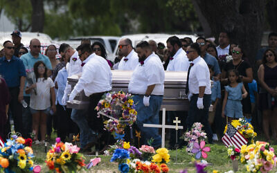 Pallbearers carry the casket of Amerie Jo Garza to her burial site in Uvalde, Texas, Tuesday, May 31, 2022. Garza was one of the students killed in last week's shooting at Robb Elementary School. (AP Photo/Jae C. Hong)