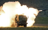 In this May 23, 2011, file photo a launch truck fires the High Mobility Artillery Rocket System (HIMARS) produced by Lockheed Martin during combat training in the high desert of the Yakima Training Center, Wash. The Biden administration is expected to announce it will send Ukraine a small number of high-tech, medium range rocket systems, US officials said Tuesday.  (Tony Overman/The Olympian via AP, File)