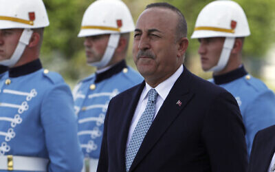 Turkish Foreign Minister Mevlut Cavusoglu stands with a military honor guard, in Ankara, Turkey, June 1, 2022. (Burhan Ozbilici/AP)