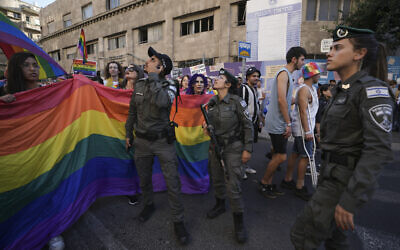 Participants march under heavy security in the annual Pride Parade, in Jerusalem, June 2, 2022. (AP Photo/Ariel Schalit)