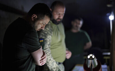 In this photo provided by the Ukrainian Presidential Press Office, Ukrainian President Volodymyr Zelensky, left, listens to a serviceman report close to front line in Donetsk region, Ukraine, June 5, 2022. (Ukrainian Presidential Press Office via AP)