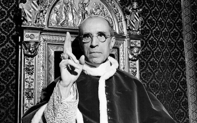 Pope Pius XII, wearing the ring of St. Peter, raises his right hand in a papal blessing at the Vatican, in Sept. 1945.  (AP Photo)