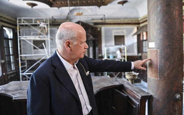 Art historian David Landau points out a restored area of a wooden column in the 1575 Italian Schola Synagogue in Venice, northern Italy, June 1, 2022. Landau is spearheading the fundraising effort to restore Venice's synagogues and nearby buildings both for Venice’s small Jewish community and for tourists who can visit them on a guided tour through the Jewish Museum of Venice. (AP Photo/Chris Warde-Jones)