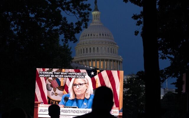 People gather in a park outside the U.S. Capitol to watch the Jan. 6 House committee investigation in Washington, Thursday, June 9, 2022. (AP Photo/Jose Luis Magana)