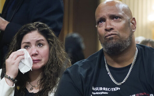 U.S. Capitol Police Sgt. Harry Dunn, right, and Sandra Garza, the long-time partner of Capitol Hill Police Officer Brian Sicknick who died shortly after the Jan. 6 attack, left, react as a video of the Jan. 6 attack on the U.S. Capitol is played during a public hearing of the House select committee investigating the attack is held on Capitol Hill, Thursday, June 9, 2022, in Washington. (AP Photo/Andrew Harnik)