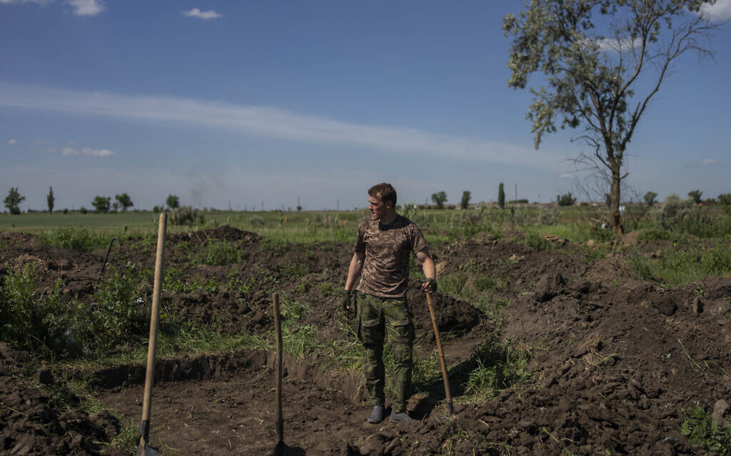 A Ukrainian serviceman digs trenches near the frontline in the Donetsk region, eastern Ukraine, June 8, 2022. (Bernat Armangue/AP)